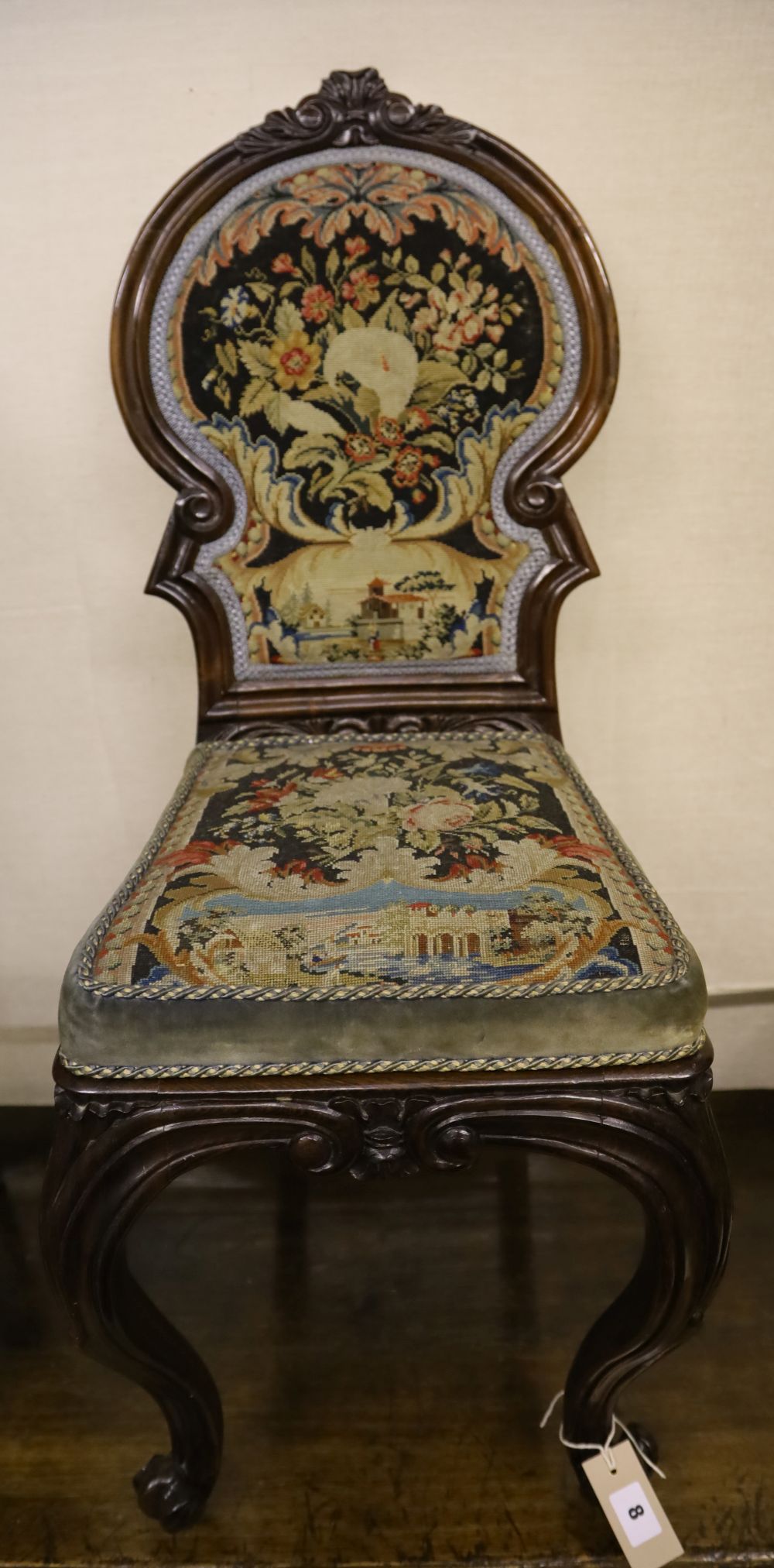 A Victorian mahogany hall seat with tapestry upholstery